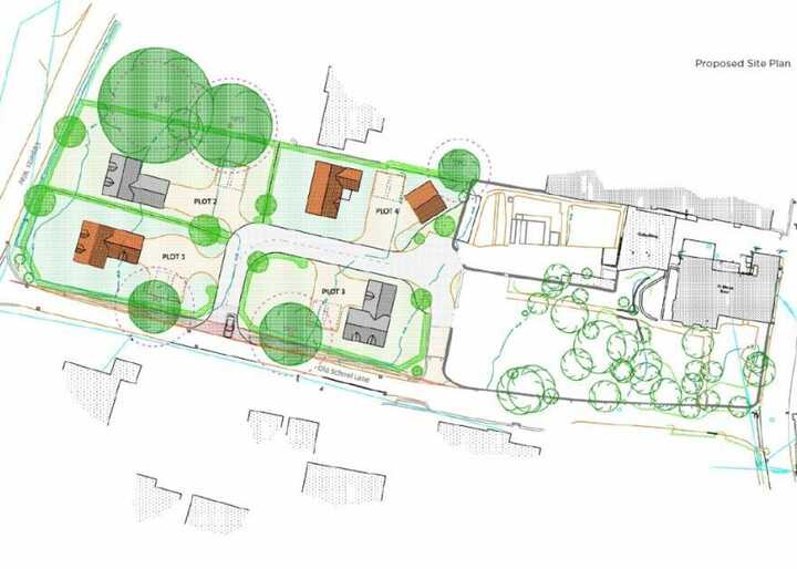 Site plan showing multiple buildings and landscaping with trees and pathways.